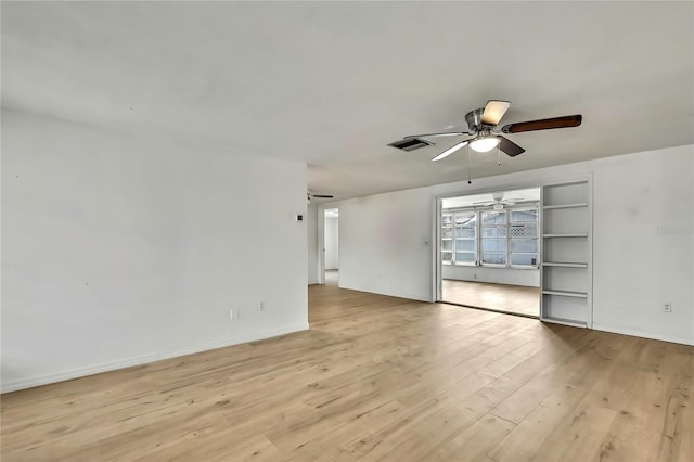 11130 White Oak Ln, Port Richey, FL 34668 - empty room with a ceiling fan, light wood-style floors, and baseboards