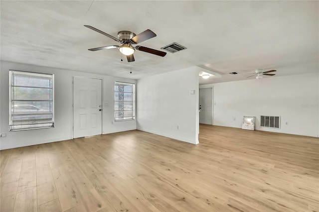 11130 White Oak Ln, Port Richey, FL 34668 - unfurnished living room with a ceiling fan, light wood-style flooring, and baseboards