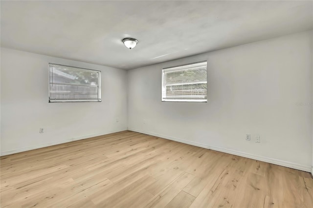 11130 White Oak Ln, Port Richey, FL 34668 - unfurnished room featuring wood finished floors and baseboards