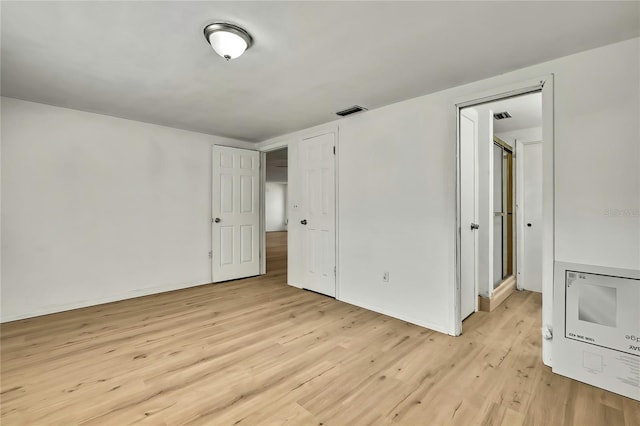 11130 White Oak Ln, Port Richey, FL 34668 - unfurnished bedroom with light wood-style floors and baseboards