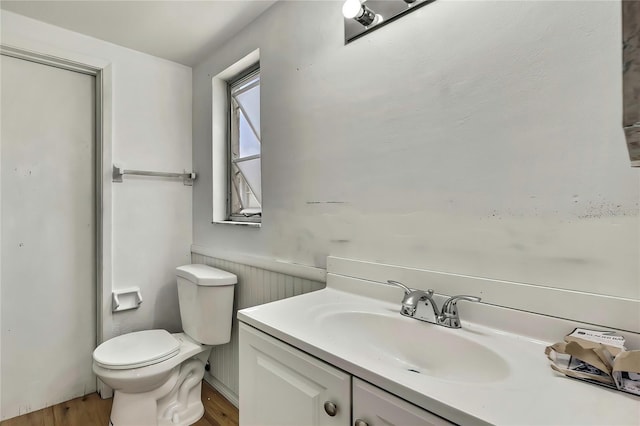 11130 White Oak Ln, Port Richey, FL 34668 - bathroom featuring wood finished floors, toilet, and vanity