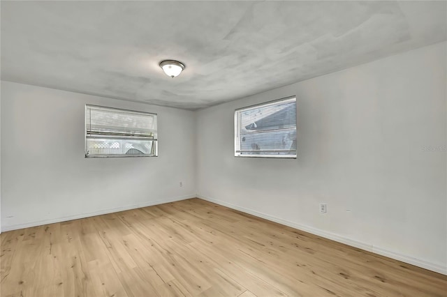 11130 White Oak Ln, Port Richey, FL 34668 - empty room with wood finished floors and baseboards