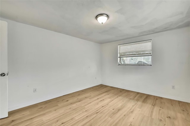 11130 White Oak Ln, Port Richey, FL 34668 - unfurnished room with wood finished floors and baseboards