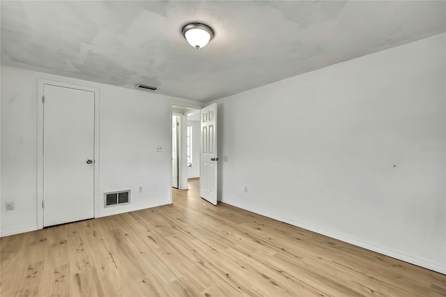11130 White Oak Ln, Port Richey, FL 34668 - unfurnished bedroom featuring light wood-type flooring and baseboards