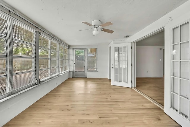 11130 White Oak Ln, Port Richey, FL 34668 - unfurnished sunroom featuring a ceiling fan, wood finished floors, and french doors