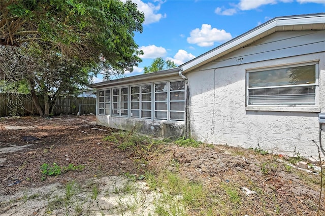 11130 White Oak Ln, Port Richey, FL 34668 - view of home's exterior with stucco siding and a sunroom