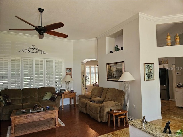 4755 N El Camino Dr, Beverly Hills, FL 34465 - living room featuring ceiling fan, arched walkways, ornamental molding, baseboards, and wood finished floors