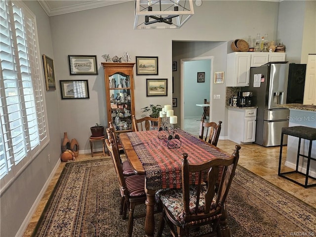 4755 N El Camino Dr, Beverly Hills, FL 34465 - dining area featuring healthy amount of natural light, crown molding, a chandelier, and baseboards
