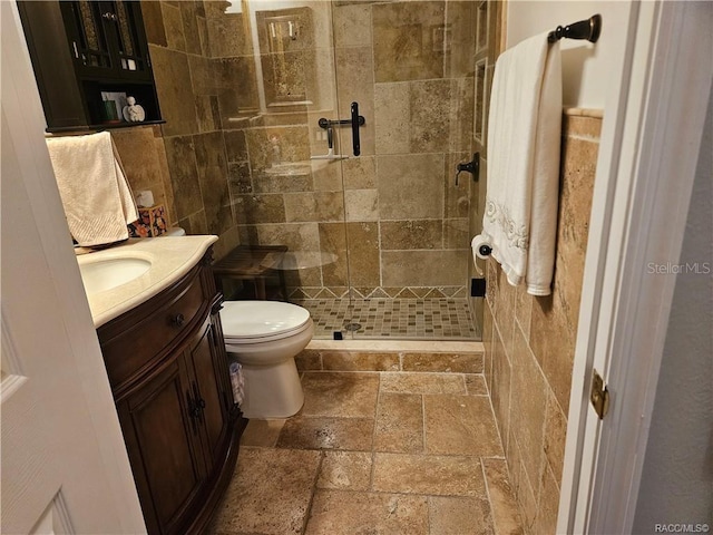 4755 N El Camino Dr, Beverly Hills, FL 34465 - bathroom with stone tile floors, vanity, a shower stall, and toilet