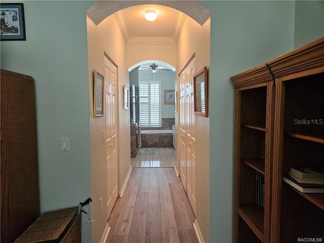 4755 N El Camino Dr, Beverly Hills, FL 34465 - hall featuring arched walkways, light wood-type flooring, and ornamental molding
