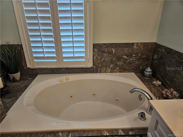 4755 N El Camino Dr, Beverly Hills, FL 34465 - bathroom featuring a tub with jets and vanity