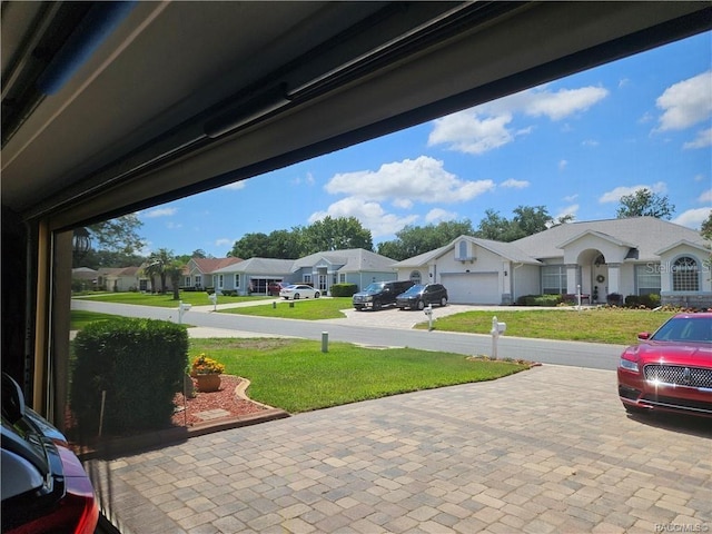 4755 N El Camino Dr, Beverly Hills, FL 34465 - view of green lawn with a residential view, driveway, and an attached garage