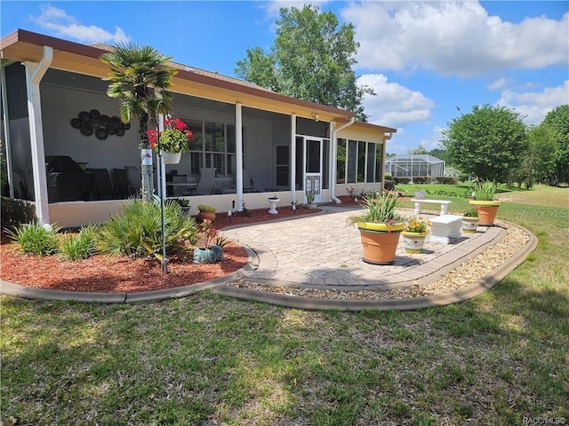 4755 N El Camino Dr, Beverly Hills, FL 34465 - back of house with a sunroom, a yard, and a patio area