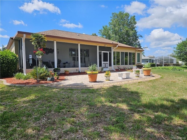 4755 N El Camino Dr, Beverly Hills, FL 34465 - back of house featuring a patio, a lawn, a sunroom, and stucco siding