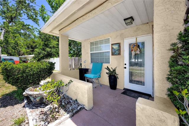 1683 Pine St, Largo, FL 33774 - doorway to property featuring stucco siding and a patio