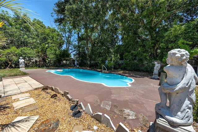1683 Pine St, Largo, FL 33774 - swimming pool featuring a patio area, view of scattered trees, and a fenced backyard