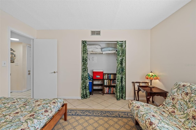17710 Gulf Blvd Unit 304, Redington Shores, FL 33708 - bedroom with light tile patterned floors and a textured ceiling