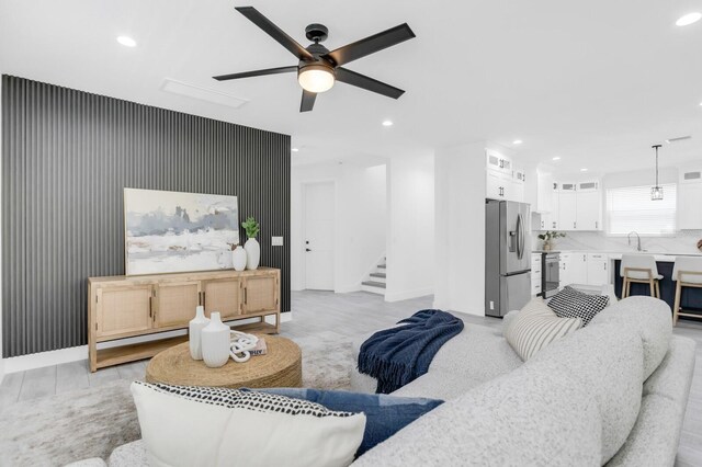 3616 W Anderson Ave, Tampa, FL 33611 - living area featuring recessed lighting, stairway, a ceiling fan, light wood-style floors, and baseboards