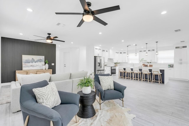3616 W Anderson Ave, Tampa, FL 33611 - living area featuring ceiling fan, recessed lighting, and light wood-style flooring