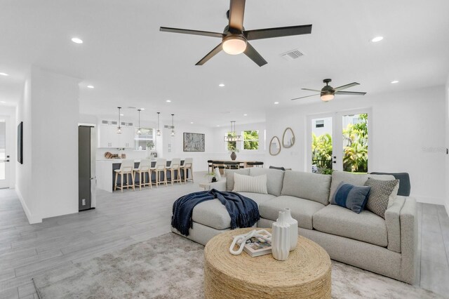 3616 W Anderson Ave, Tampa, FL 33611 - living room with a ceiling fan, light wood finished floors, and recessed lighting