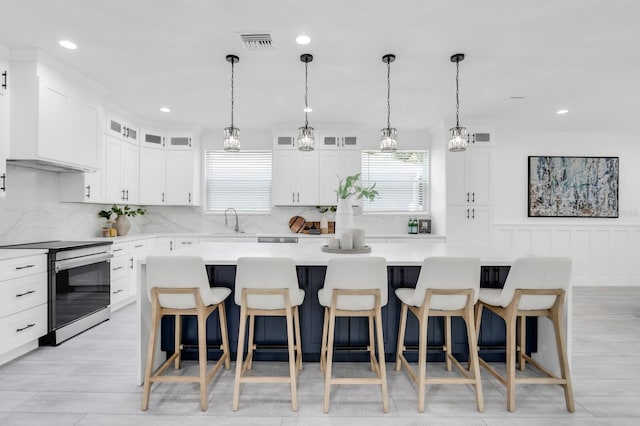 3616 W Anderson Ave, Tampa, FL 33611 - kitchen with stainless steel electric range oven, a sink, backsplash, light countertops, and recessed lighting