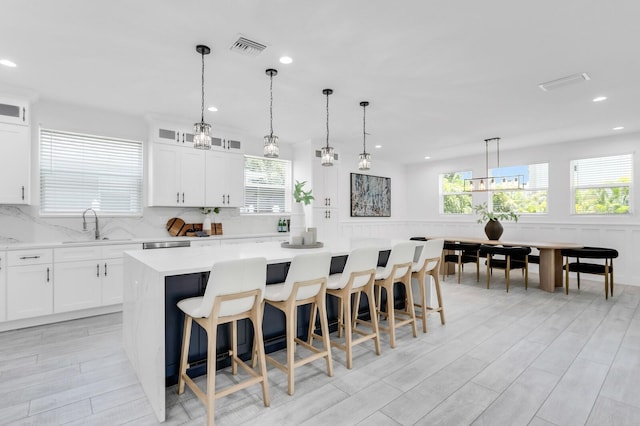 3616 W Anderson Ave, Tampa, FL 33611 - kitchen featuring a center island, a sink, light countertops, backsplash, and recessed lighting