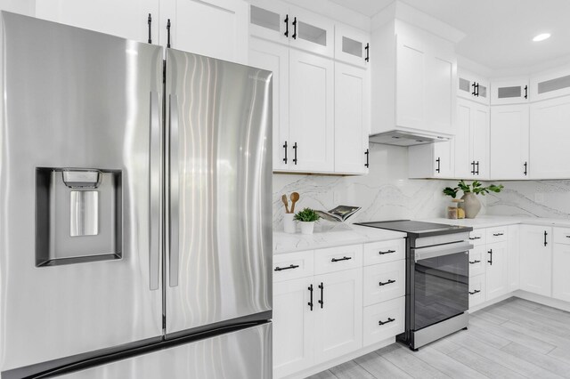 3616 W Anderson Ave, Tampa, FL 33611 - kitchen with stainless steel appliances, light stone countertops, backsplash, glass insert cabinets, and recessed lighting