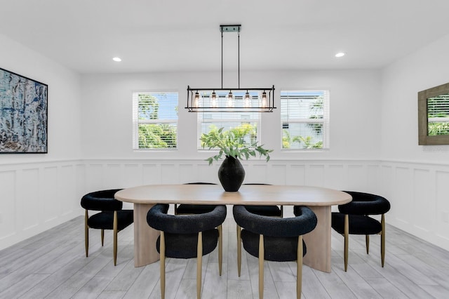 3616 W Anderson Ave, Tampa, FL 33611 - dining space featuring plenty of natural light, a decorative wall, wainscoting, light wood finished floors, and recessed lighting
