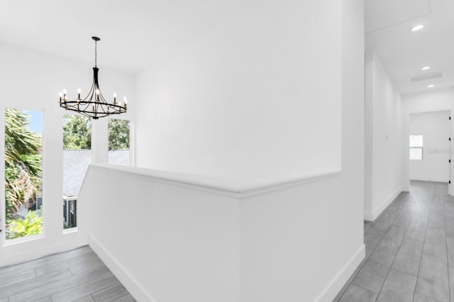 3616 W Anderson Ave, Tampa, FL 33611 - hall featuring baseboards, a chandelier, plenty of natural light, recessed lighting, and light wood finished floors