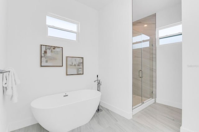 3616 W Anderson Ave, Tampa, FL 33611 - bathroom with a shower stall, a freestanding tub, and baseboards