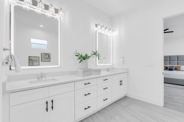 3616 W Anderson Ave, Tampa, FL 33611 - full bathroom with double vanity, ensuite bathroom, and baseboards
