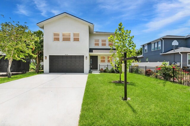 3616 W Anderson Ave, Tampa, FL 33611 - view of front of home featuring a garage, stucco siding, and driveway