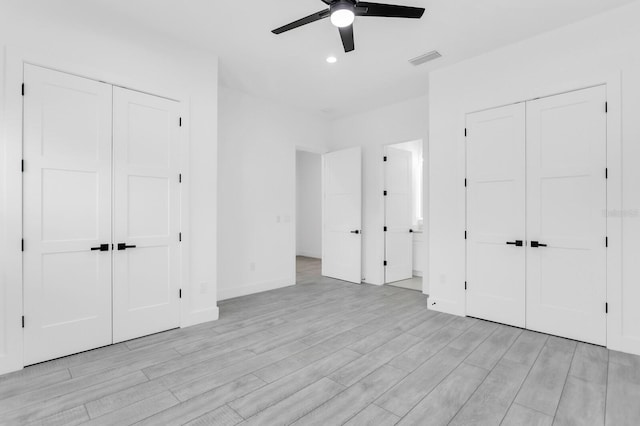 3616 W Anderson Ave, Tampa, FL 33611 - unfurnished bedroom featuring multiple closets, light wood-style floors, recessed lighting, baseboards, and a ceiling fan