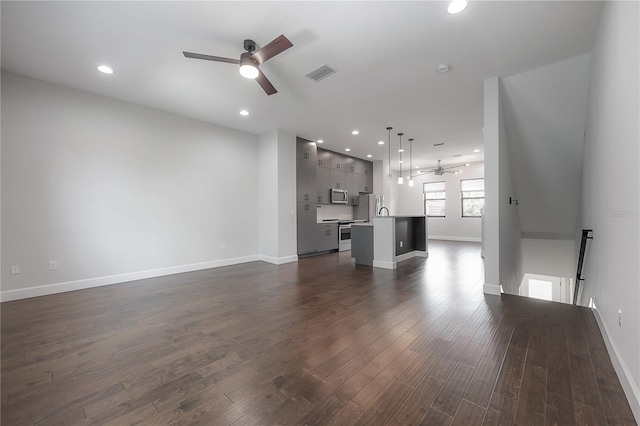 1330 W Gray St Unit 1, Tampa, FL 33606 - unfurnished living room featuring ceiling fan, dark wood-style flooring, baseboards, and recessed lighting