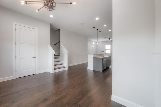 1330 W Gray St Unit 1, Tampa, FL 33606 - unfurnished living room with stairway, dark wood finished floors, recessed lighting, baseboards, and a sink