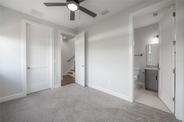 1330 W Gray St Unit 1, Tampa, FL 33606 - unfurnished bedroom featuring light colored carpet, connected bathroom, and baseboards