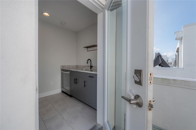 1330 W Gray St Unit 1, Tampa, FL 33606 - laundry area featuring a sink and light tile patterned flooring