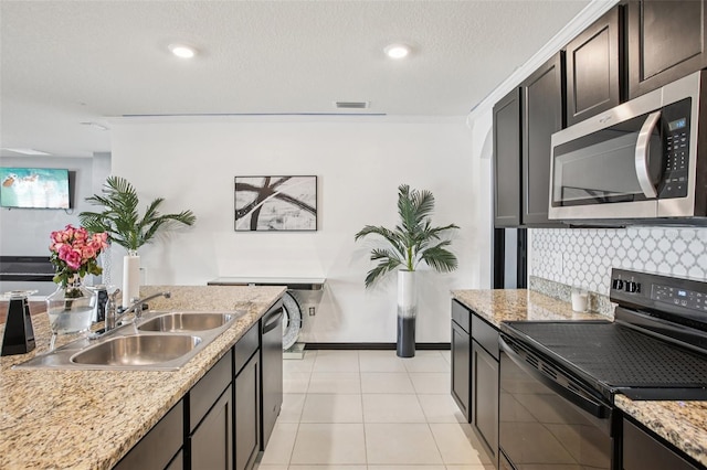 10233 Opaline Sky Pl, Riverview, FL 33578 - kitchen with stainless steel appliances, a sink, decorative backsplash, dark brown cabinets, and recessed lighting
