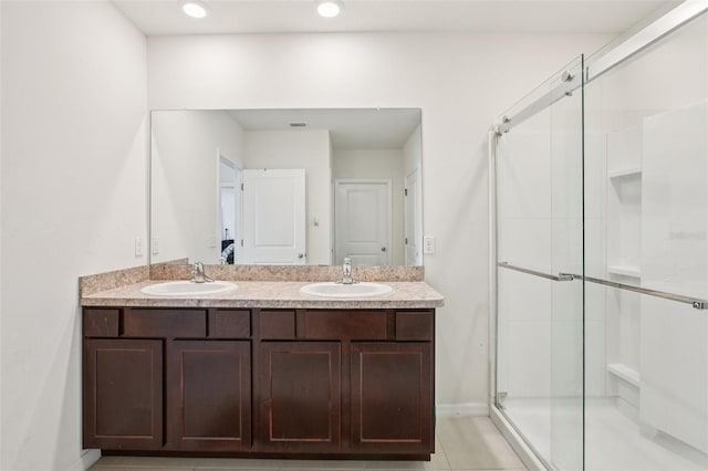 10233 Opaline Sky Pl, Riverview, FL 33578 - full bath with double vanity, a shower stall, recessed lighting, tile patterned floors, and baseboards