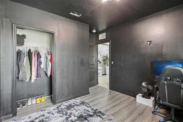 10233 Opaline Sky Pl, Riverview, FL 33578 - bedroom featuring wood finished floors, an office area, a closet, and a textured wall