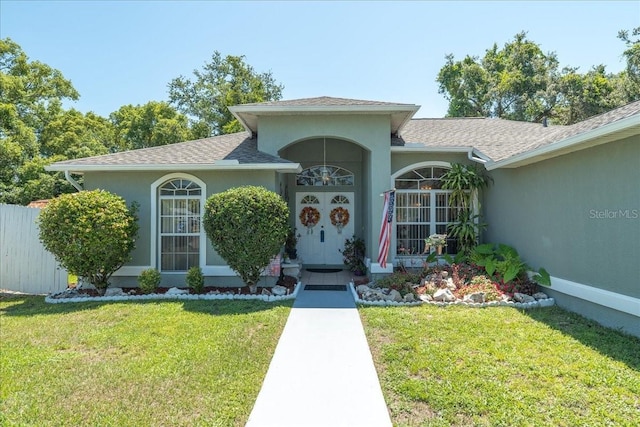 2826 Martha Ln, Land O Lakes, FL 34639 - entrance to property featuring a lawn, stucco siding, and a shingled roof