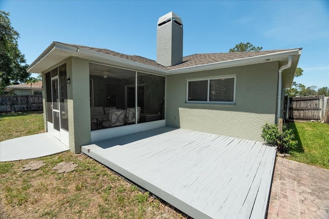 2826 Martha Ln, Land O Lakes, FL 34639 - rear view of property with a sunroom, a chimney, a deck, and stucco siding