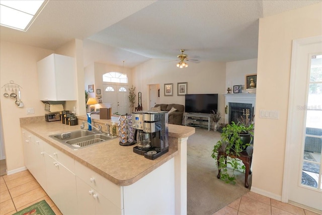 2826 Martha Ln, Land O Lakes, FL 34639 - kitchen featuring a sink, a peninsula, light tile patterned floors, and light countertops