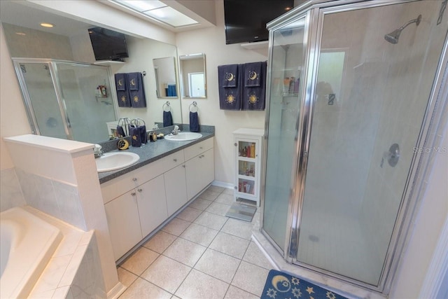 2826 Martha Ln, Land O Lakes, FL 34639 - full bathroom featuring a shower stall, double vanity, tile patterned floors, a bath, and baseboards