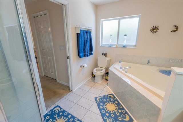 2826 Martha Ln, Land O Lakes, FL 34639 - bathroom featuring toilet, a garden tub, tile patterned floors, baseboards, and an enclosed shower
