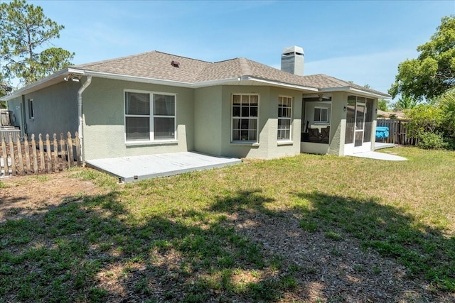 2826 Martha Ln, Land O Lakes, FL 34639 - rear view of property featuring stucco siding, a sunroom, a chimney, and roof with shingles