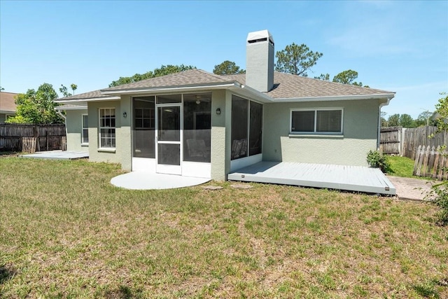 2826 Martha Ln, Land O Lakes, FL 34639 - back of property featuring a sunroom, a chimney, stucco siding, and a shingled roof