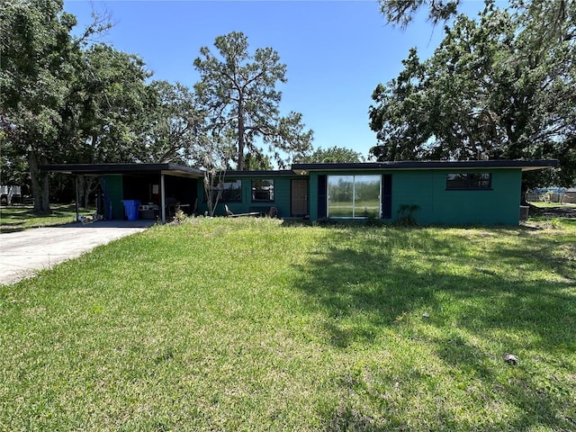 314 Dickman Dr SW, Ruskin, FL 33570 - view of front of house featuring a front lawn, an attached carport, and driveway