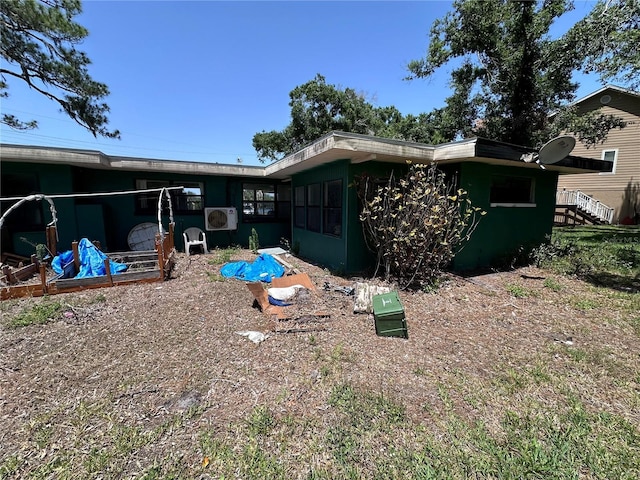 314 Dickman Dr SW, Ruskin, FL 33570 - rear view of house with ac unit and a sunroom