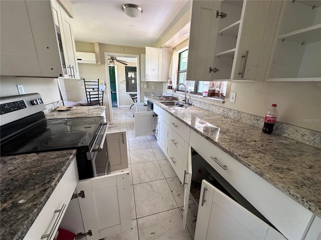 314 Dickman Dr SW, Ruskin, FL 33570 - kitchen with a sink, light stone countertops, electric stove, and white cabinetry